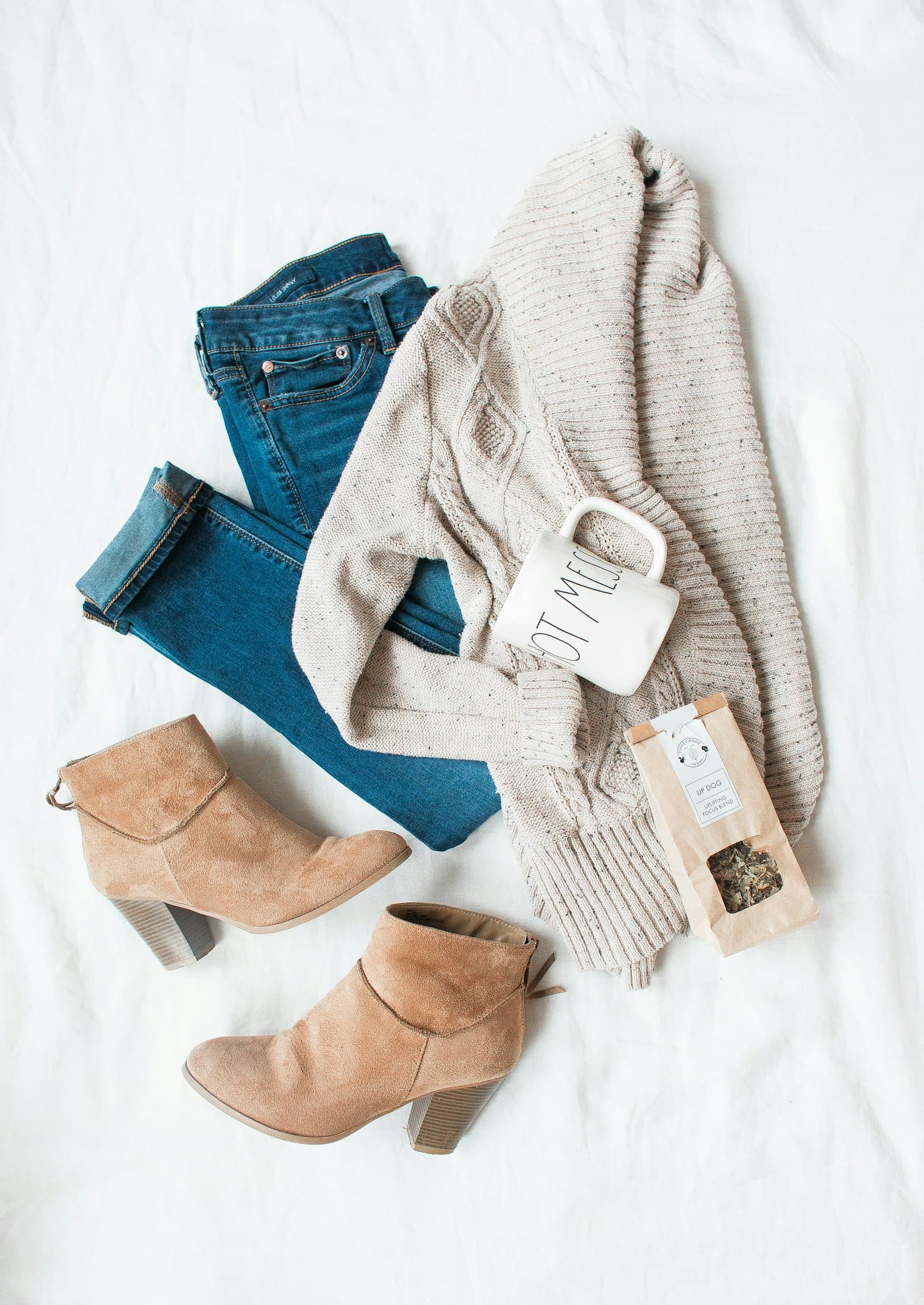 Winter layered fashion look with coat, knitwear, and scarf outdoors